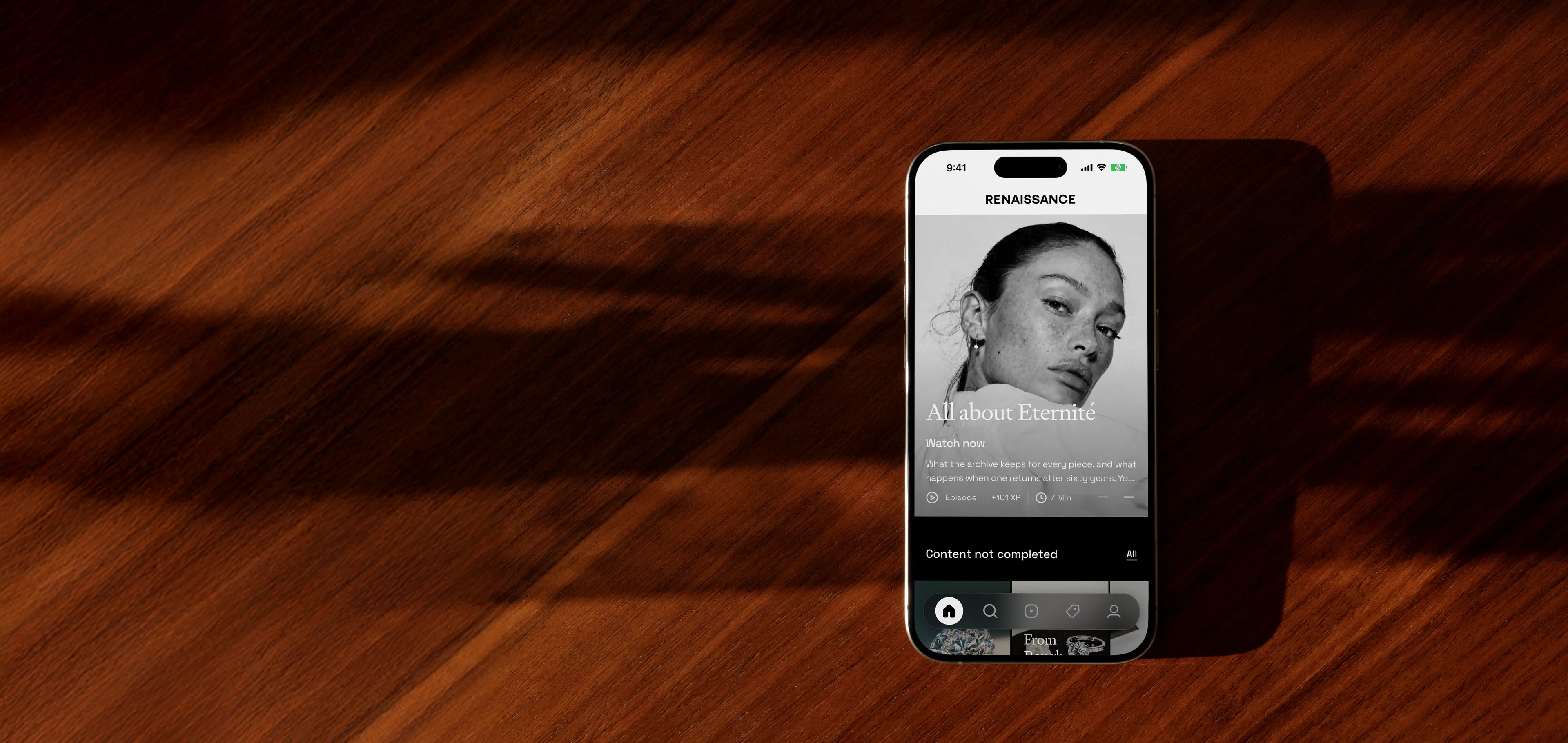 The Renaissance app on its home screen, phone on a wooden desk
